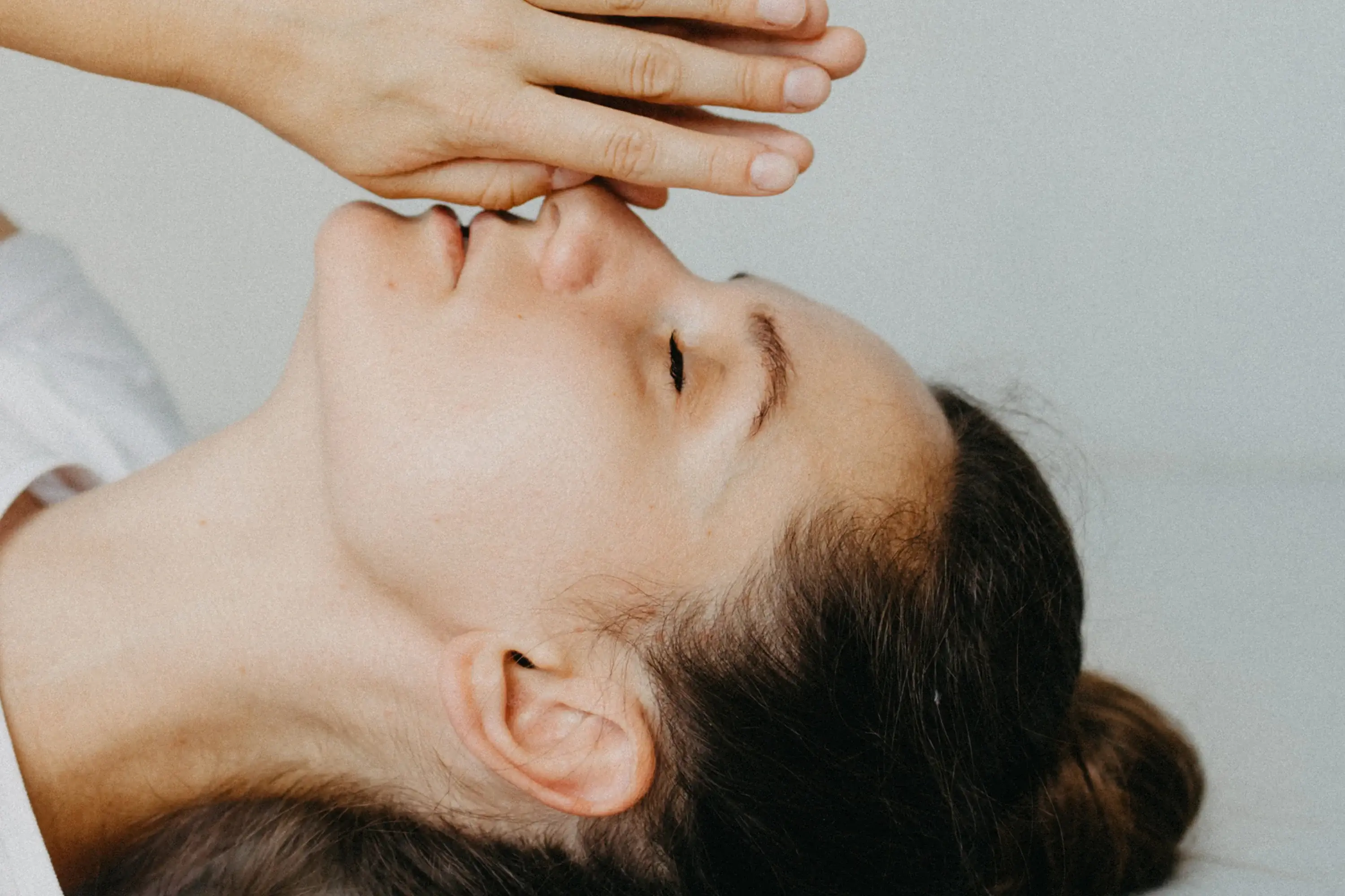 a woman with her eyes closed doing breathwork